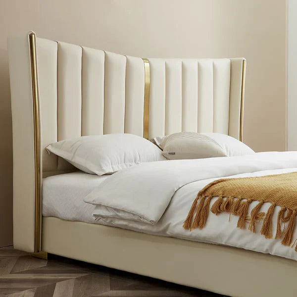 A bed with mattress cream and gold colour