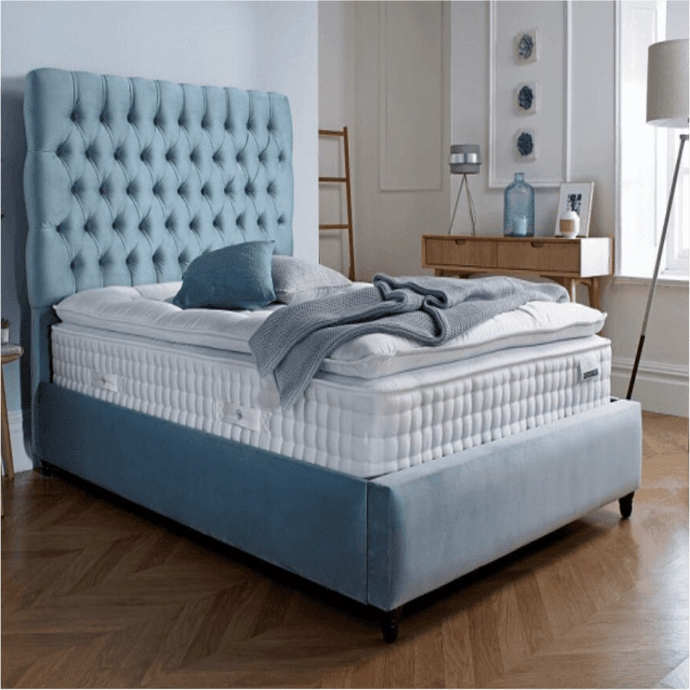 A bed with mattress sky blue colour