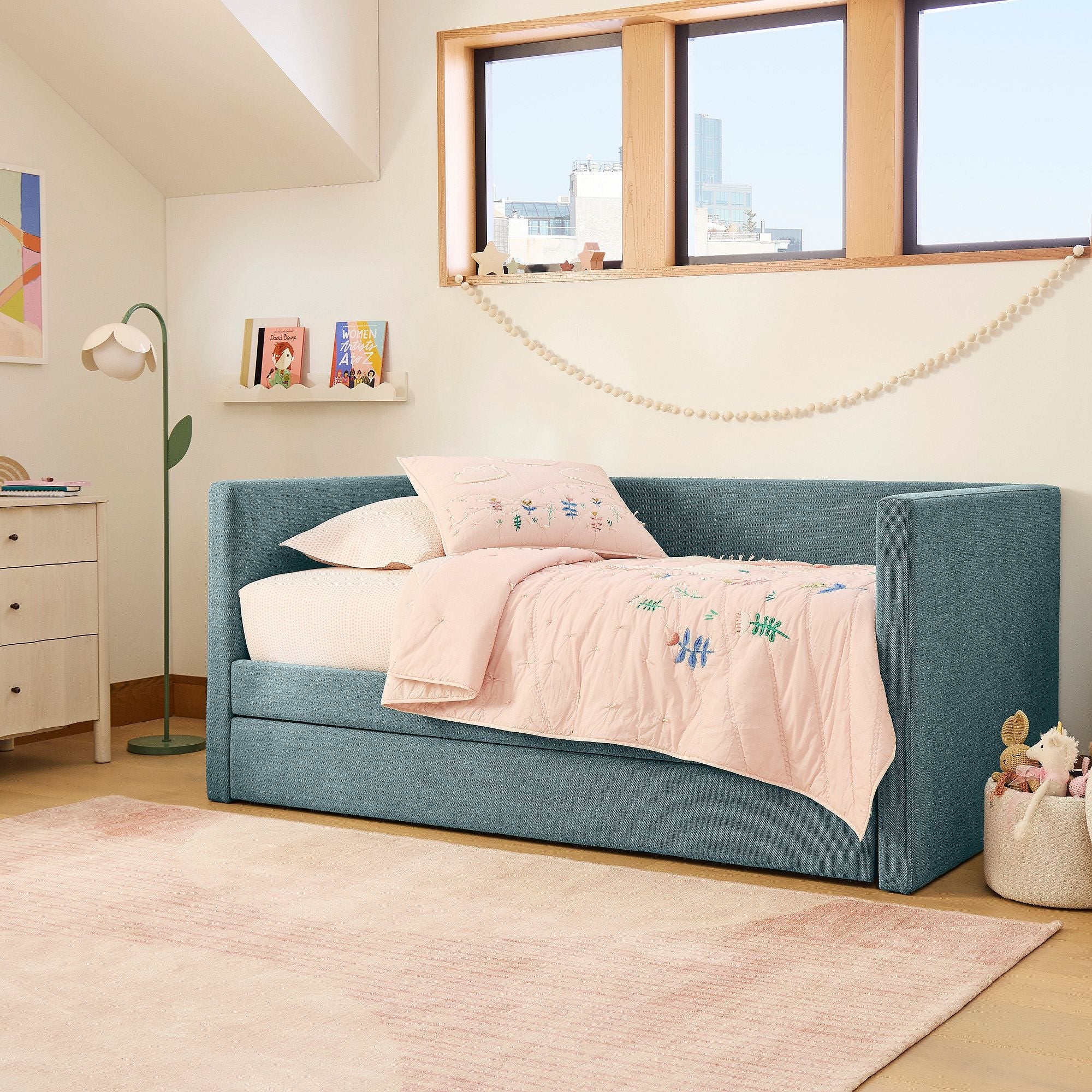 Blue upholstered bed with pink