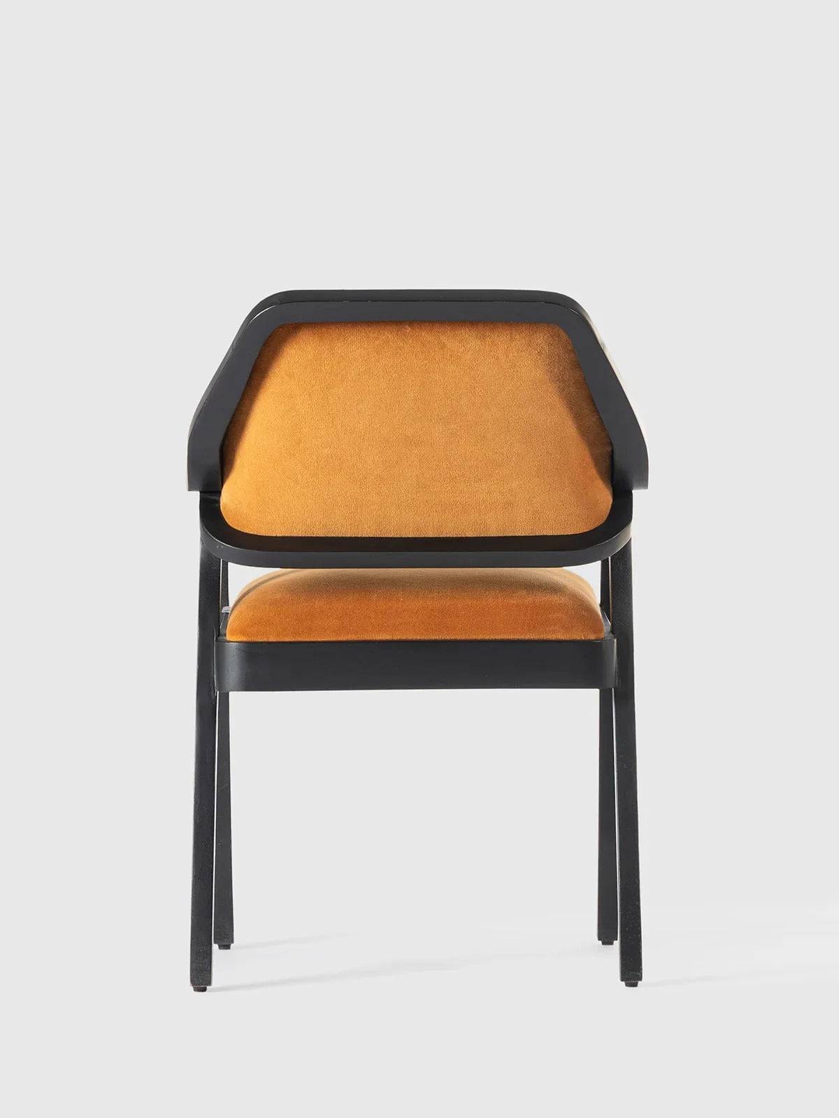 Mustard velvet modern armchair.