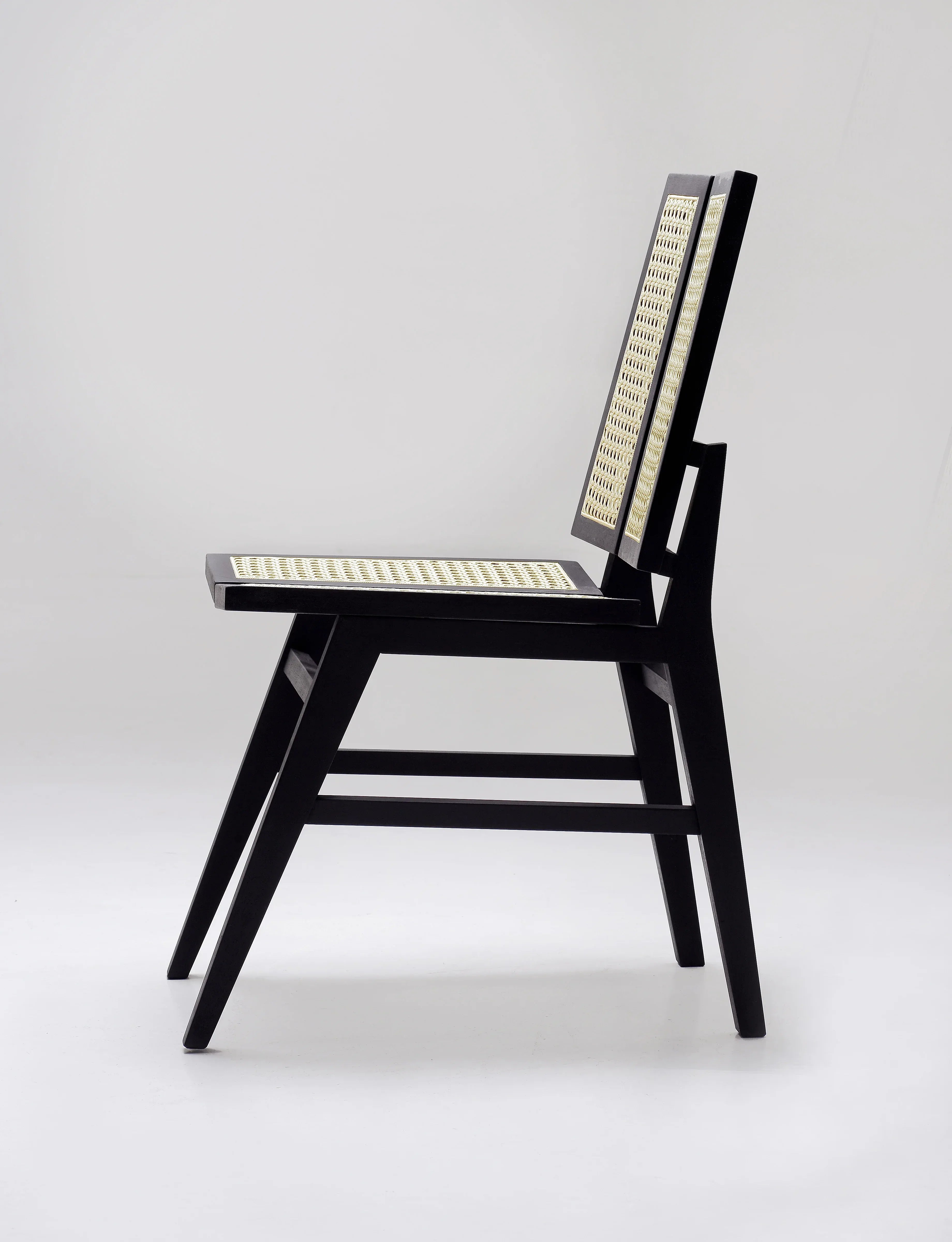 Split-back black cane Dining chair.