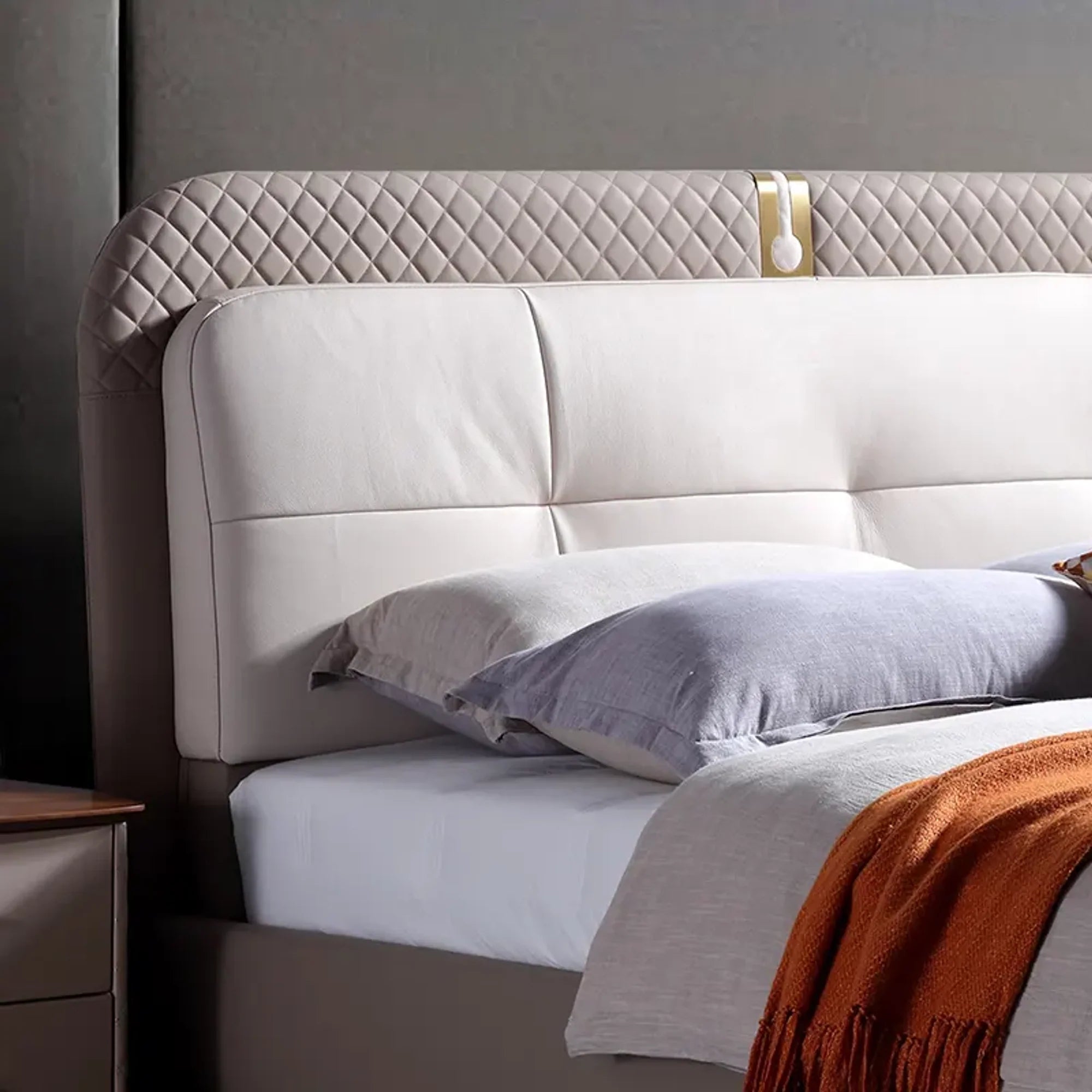 A bed with mattress grey and white colour